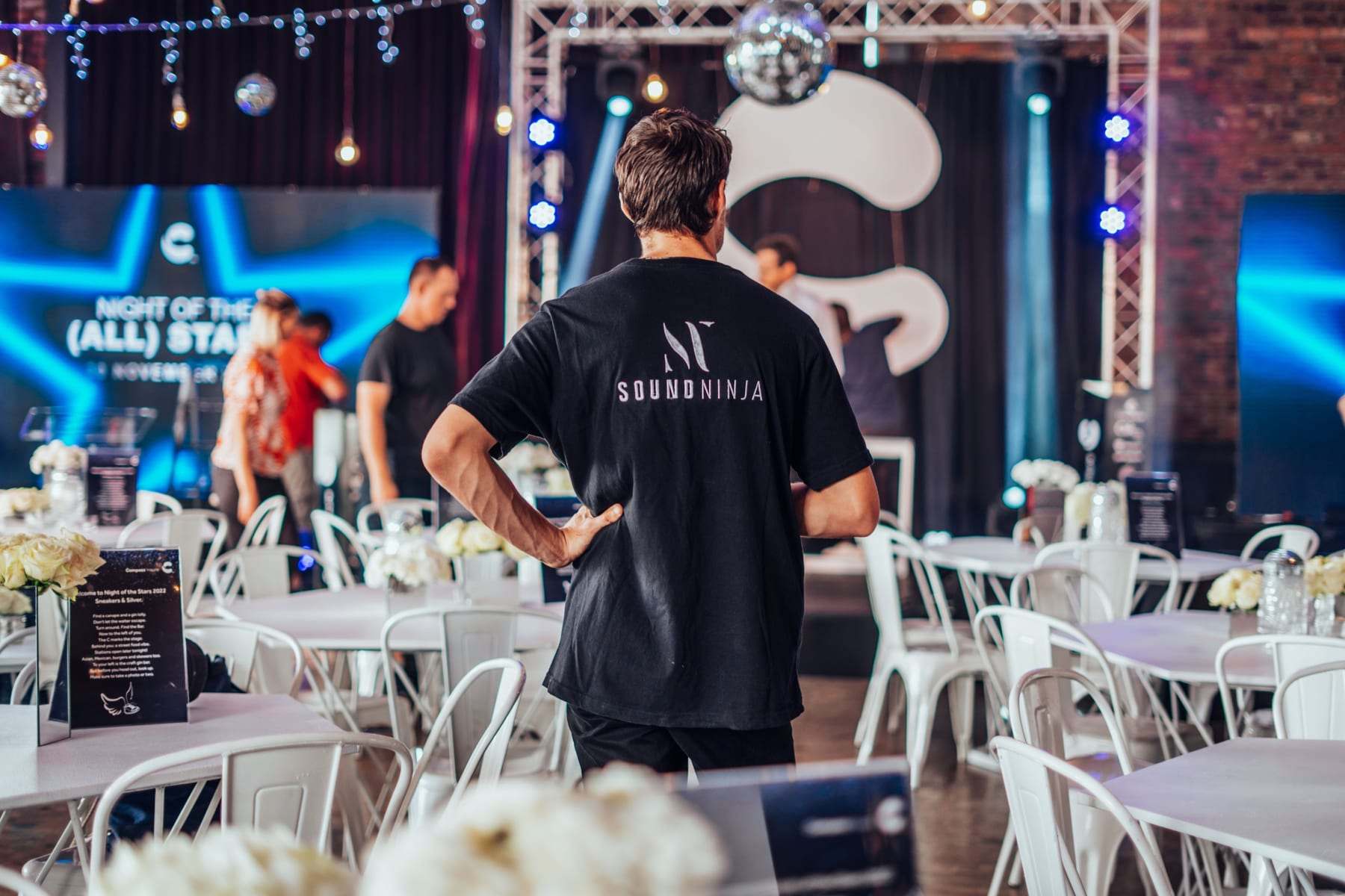 A Sound Ninja crew member facing the stage, with Night of the (All) Stars on the LED screens