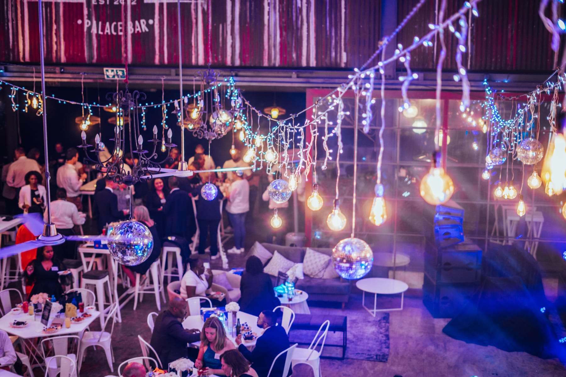 Guests under festoon lights and mirror balls at the awards night