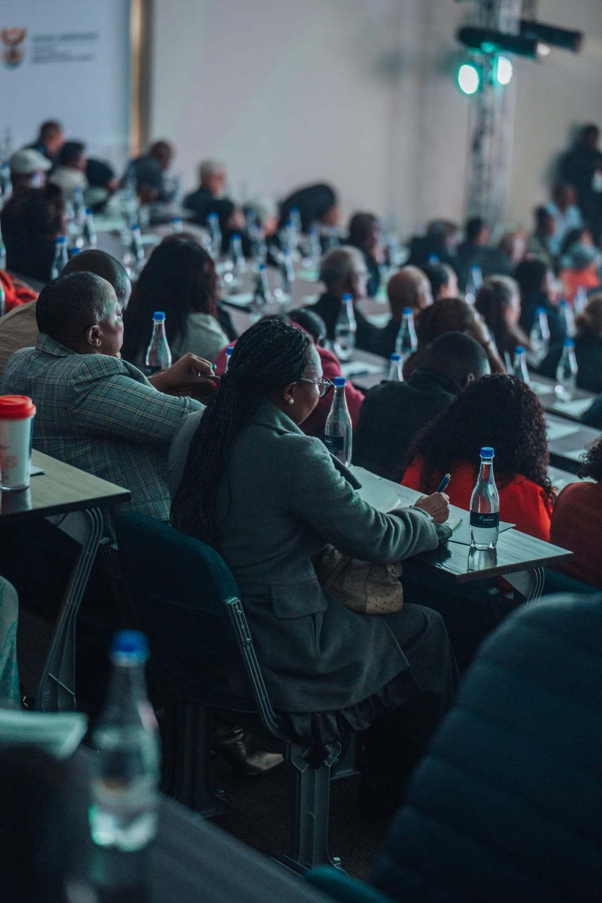 Delegates at round tables in the main room