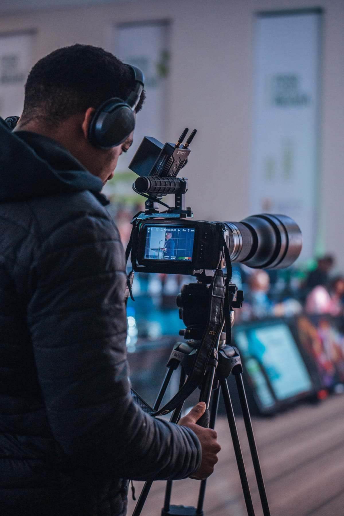 A camera operator filming the stage