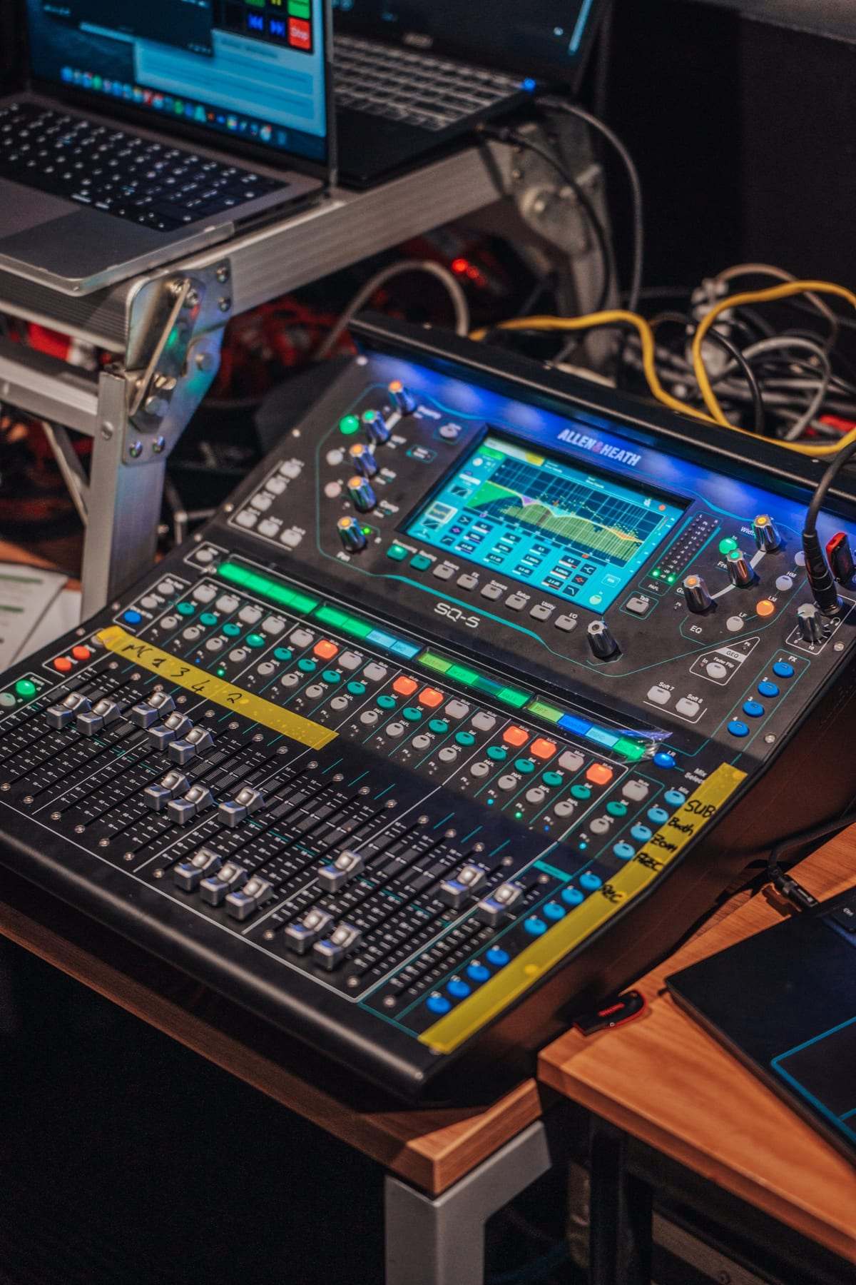 A digital mixing desk at the back of the room