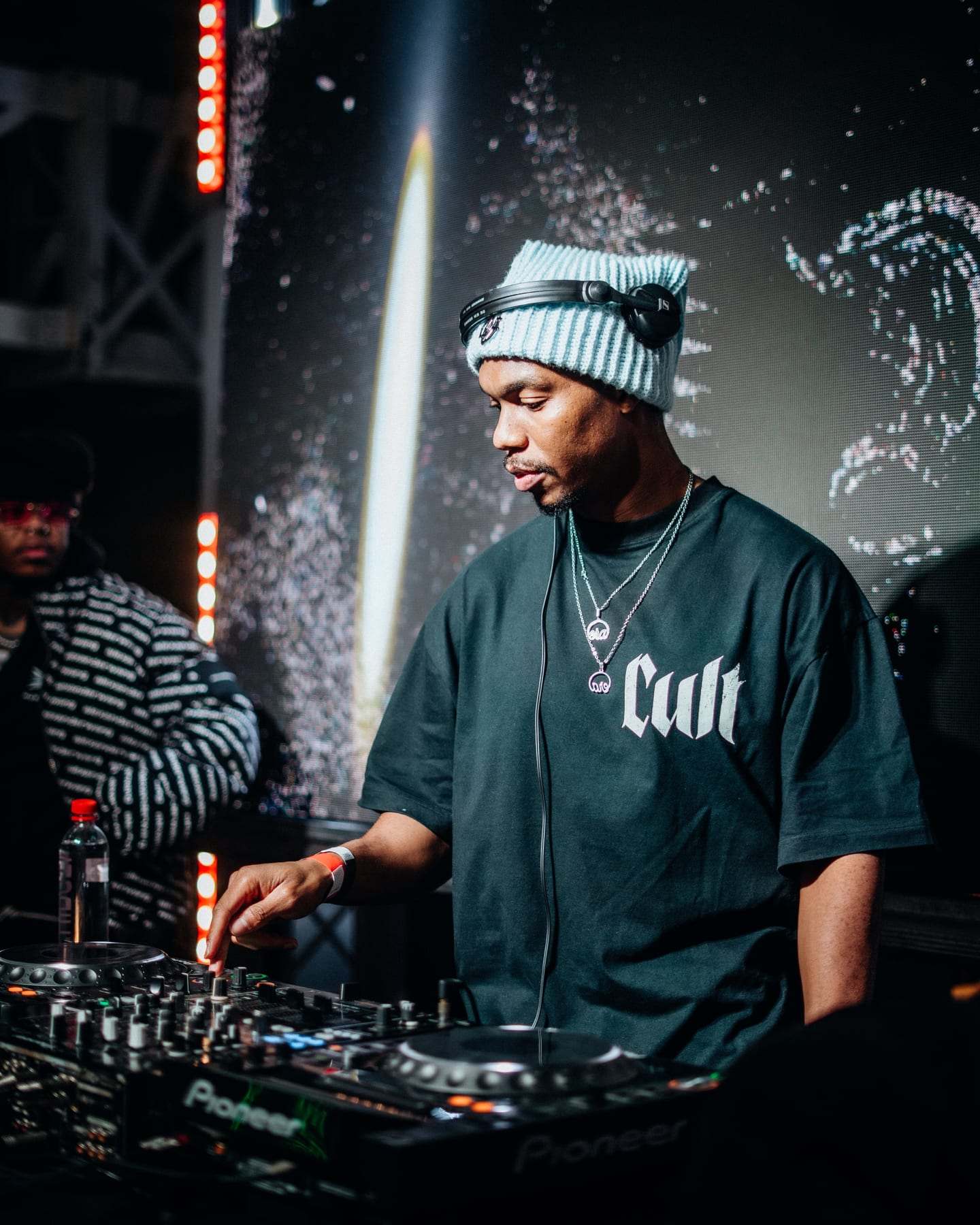 The DJ on the decks in front of the LED screen