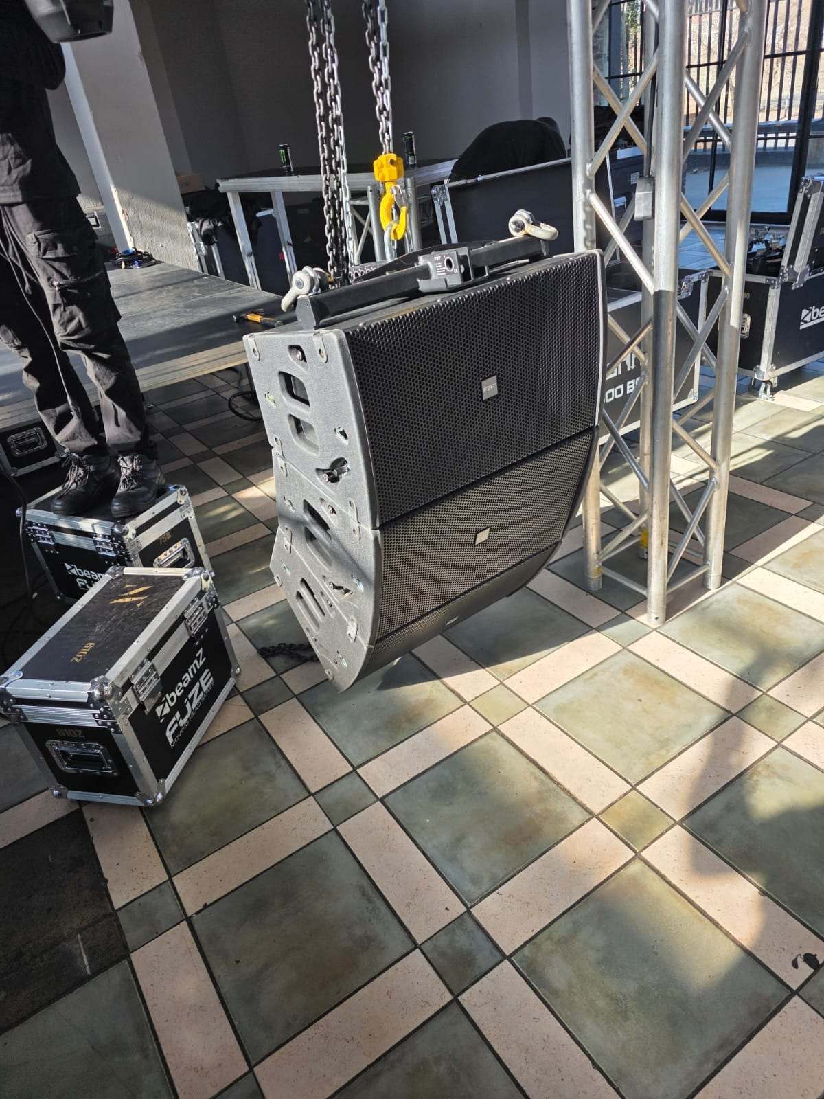 Line-array speakers on a rigging frame, ready to fly on chain motors