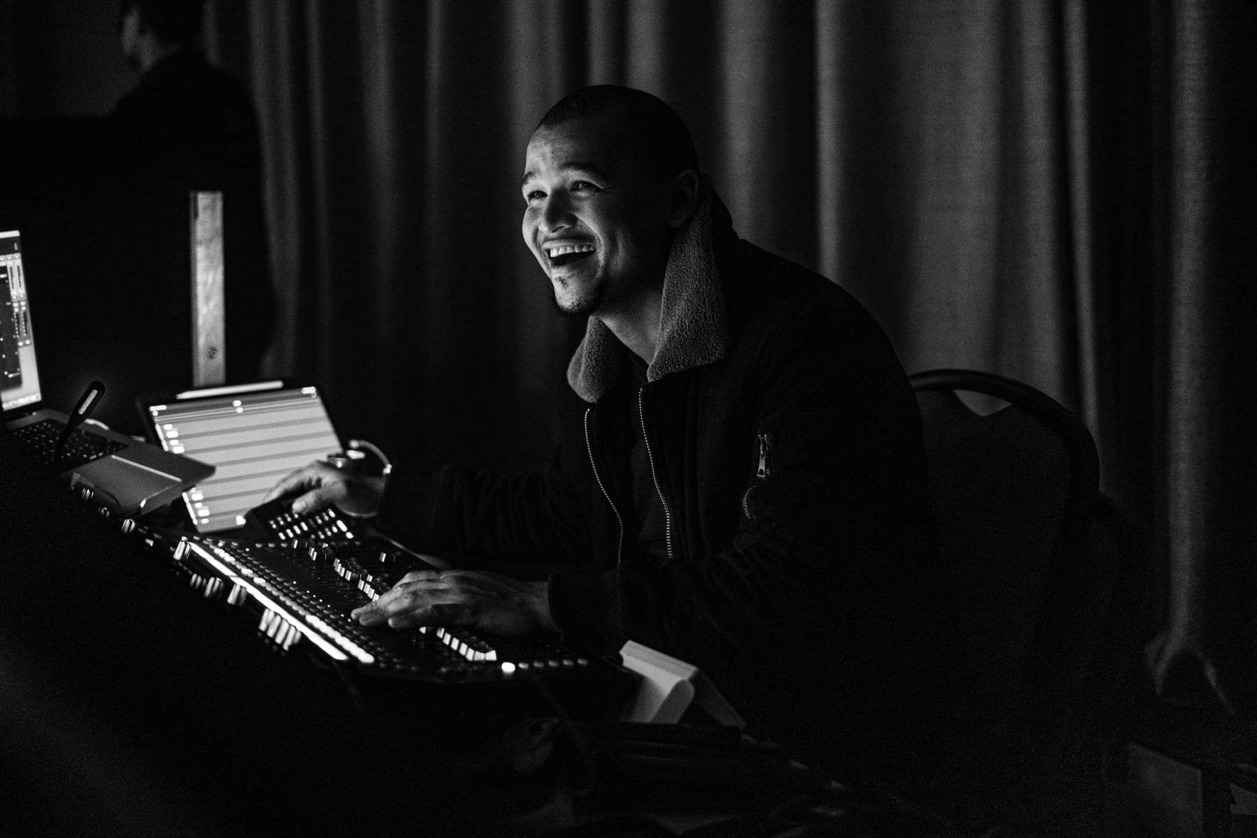 Our sound engineer smiling at the mixing desk during the Haleon gala