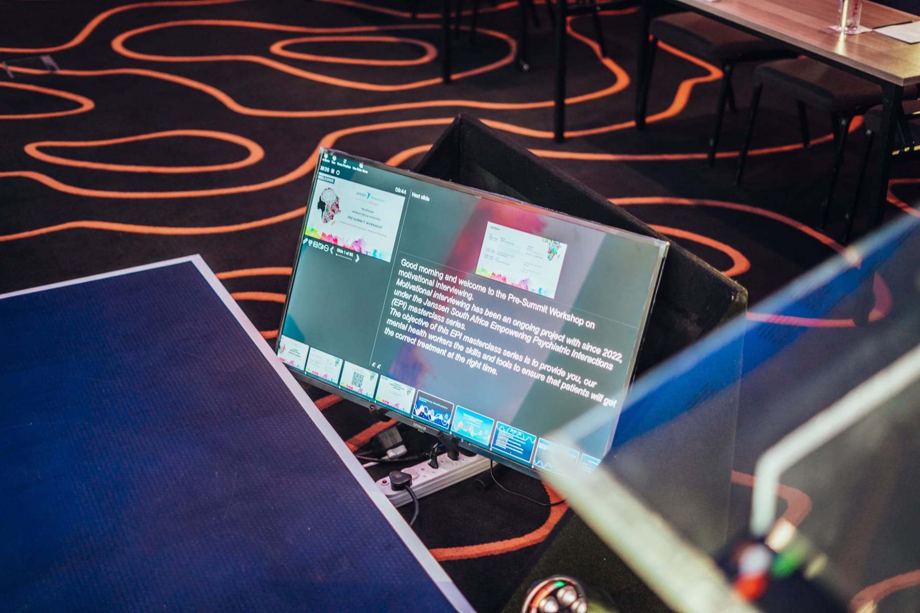 A confidence monitor at the front of the stage showing the speaker's notes