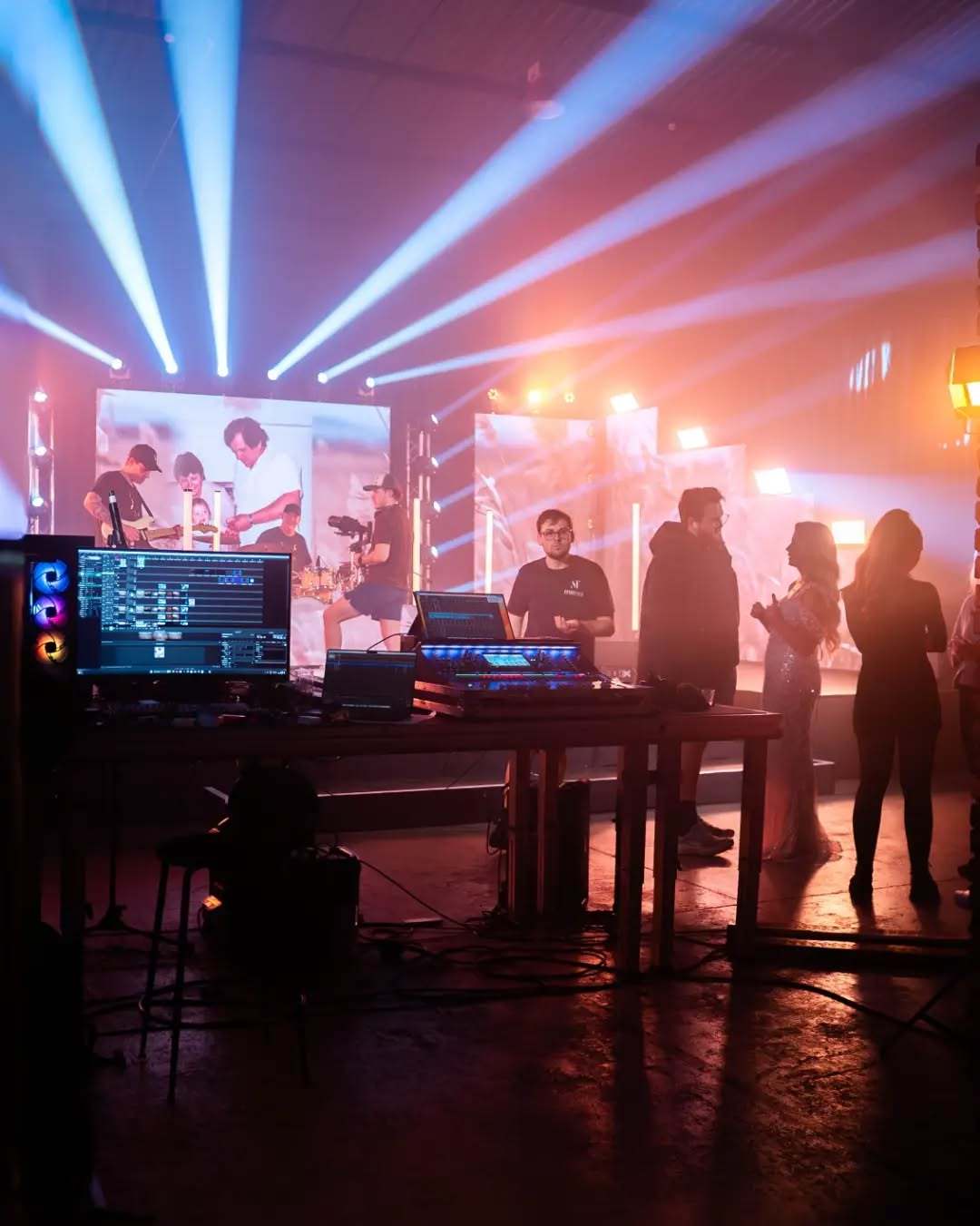 A stage with warm beams and haze during a music shoot