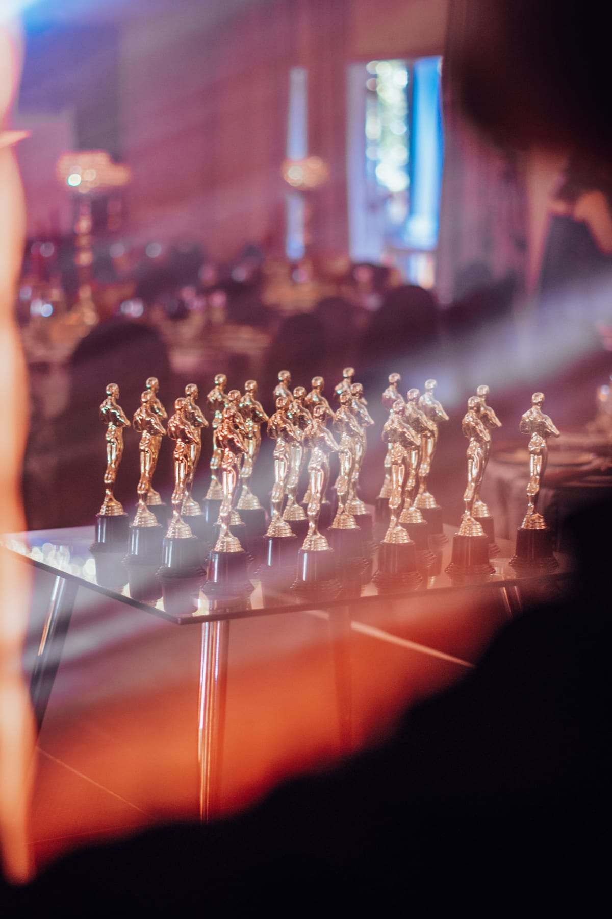 Gold award statuettes on a table, ready for the Oscars-themed awards