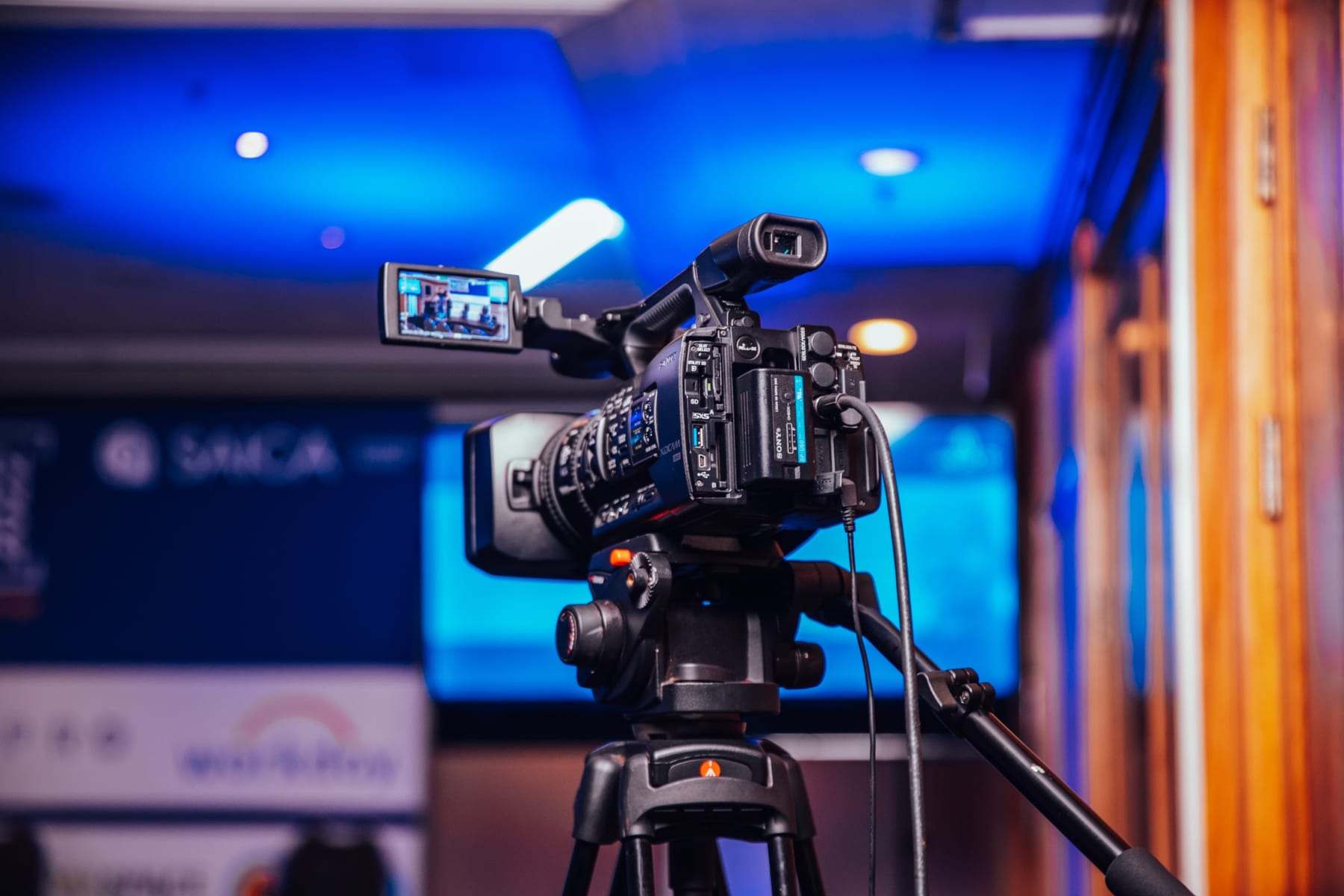 A camera on a tripod filming the stage at SAICA's 2022 conference