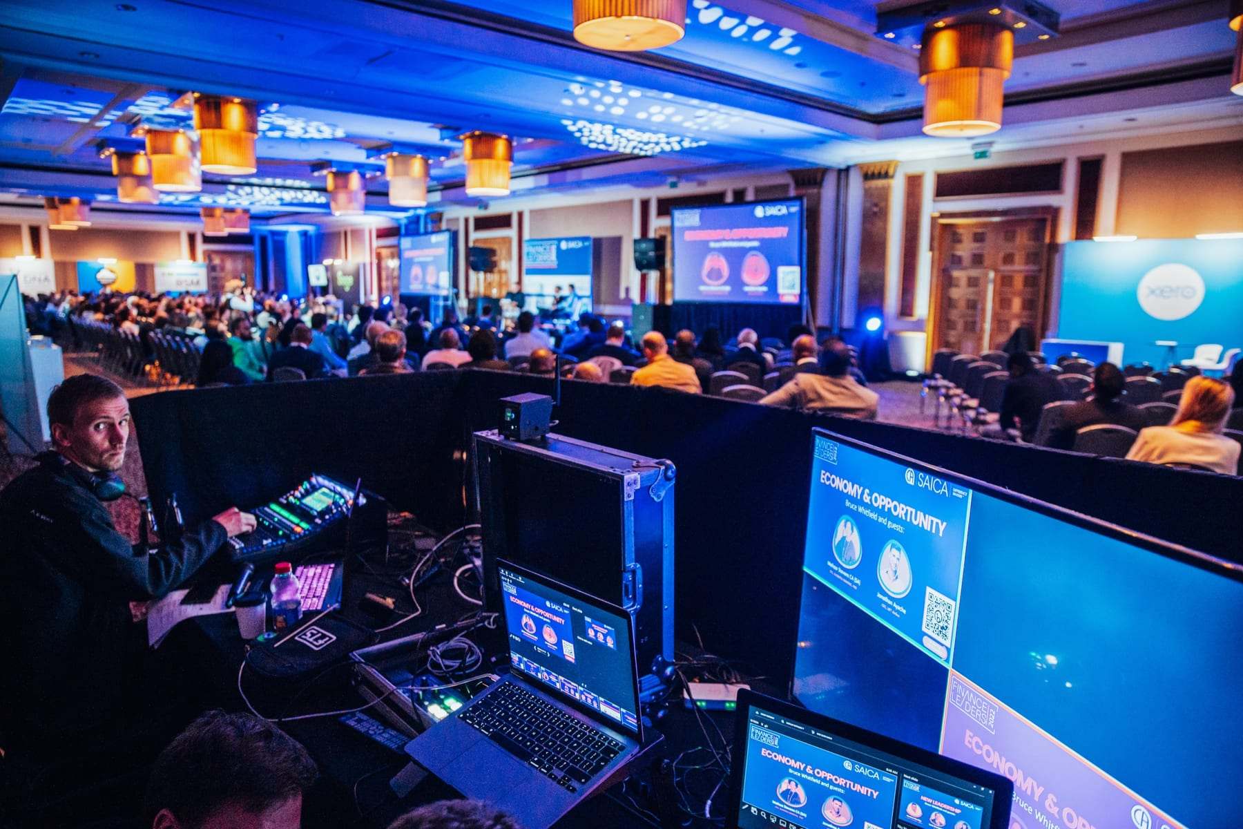 The control area with monitors facing a full conference room