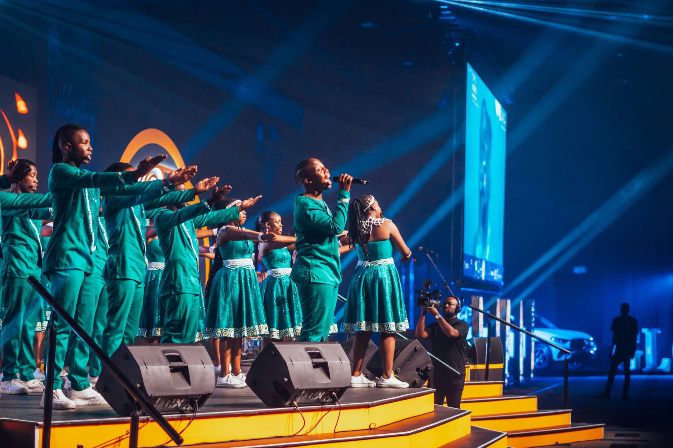 Performers on stage with monitor wedges at the SAICA gala