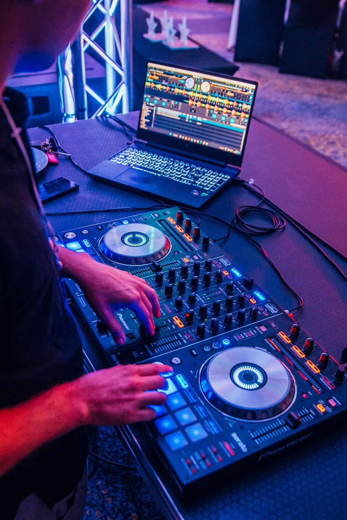 Hands on a DJ controller with a laptop at a Sorbet event